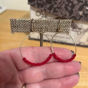 Gold tone dangle hoop with red beading, pierced